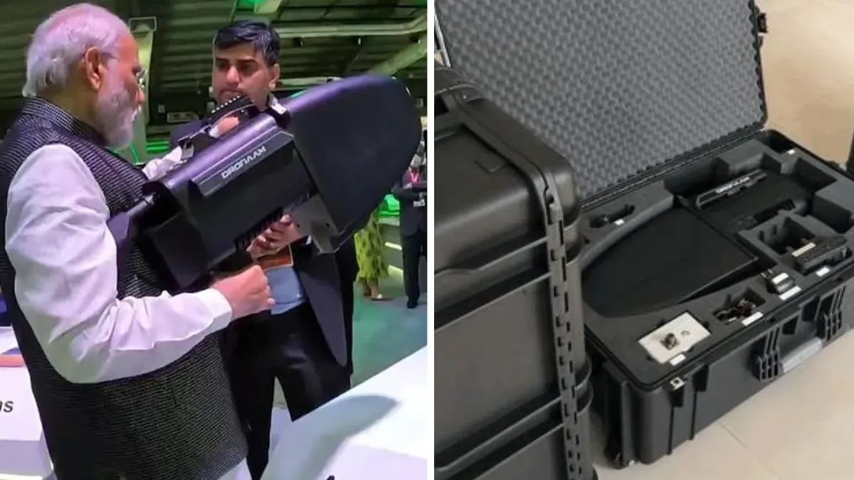 PM Narendra Modi holding anti-drone gun Dronaam in Defence expo 2022