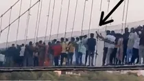 old video of youth kicking morbi bridge cable