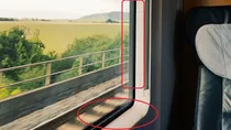 Why are there black dots on the glass windows of cars, trains, and buses?