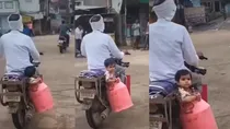 Child sitting in milk container