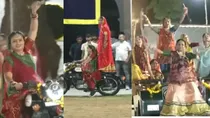 women playing garba by swords on bikes