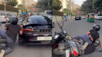 bike scooty tailing McLaren supercar accident video funny viral bengaluru