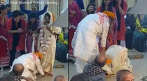 groom touches brides feet wedding