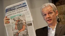  'WikiLeaks', Julian Assange holds up a copy of today's Guardian newspaper during a press conference in London on July 26, 2010. (AFP)