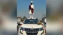 groom on car posing for photo