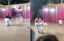 Barati attend marriage in flood water (photo-screengrab)