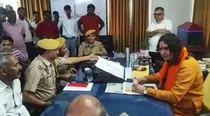Balmukund Acharya sits on police officers chair 