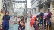 Murshidabad teacher not coming school on time children are getting drenched in the rain outside