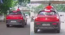 sunroof stunt in bengaluru boy hits head on road barrier video viral