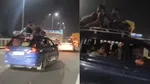 filmy stunt in meerut expressway by travelling in car roof police issued challan after video got viral