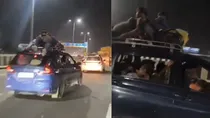 filmy stunt in meerut expressway by travelling in car roof police issued challan after video got viral