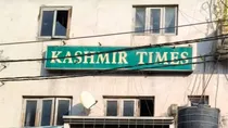 Kashmir Times office raided AK rifle cartridges recovered editors slam action