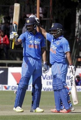 Indian batsman Manish Pandey (L) is congratulated after scoring 50 runs by fellow batsman Kedar Jadhav during their third One Day International cricket match against Zimbabwe in Harare, July 14,2015. REUTERS/Philimon Bulawayo - RTX1KA67