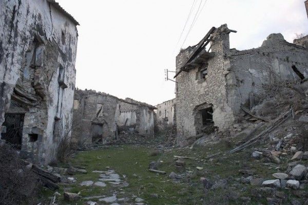 Ruined houses line the main street of the village of Esco near the Yesa reservoir in Aragon March 22, 2012. The Aragonese community, dating back over 700 years, was forced to abandon its self sufficient way of life after the flooding of their agricultural lands, following the construction of the Yesa dam across the nearby Aragon River. Locals are protesting a proposed enlargement of the barrier, which was inaugurated in 1960 by General Francisco Franco. Picture taken March 22, 2012. REUTERS/Vincent West (SPAIN - Tags: ENVIRONMENT TRAVEL)