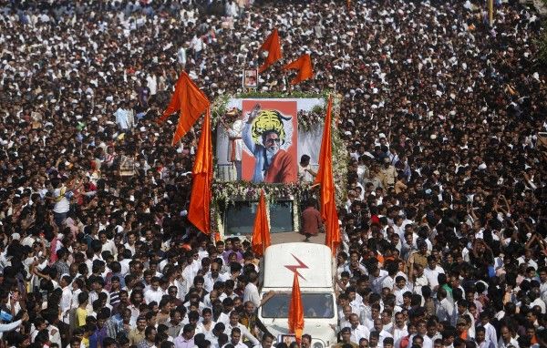Supports of the Shiv Sena party crowd around the vehicle carrying the body of right-wing Hindu nationalist politician Bal Thackeray during his funeral procession in Mumbai, November 18, 2012. Thackeray, one of India's most polarising politicians and leader of an influential right-wing Hindu nationalist party that has dominated politics in the country's richest city for two decades, has died aged 86. Thackeray died of cardio-respiratory arrest on Saturday at his home, one of his doctors, Jalil Parker, said. He had been ill for some time and was rumoured to have died earlier this week. REUTERS/Vivek Prakash (INDIA - Tags: POLITICS OBITUARY)