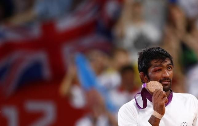 India's Yogeshwar Dutt poses with his bronze medal at the podium of the Men's 60Kg Freestyle wrestling at the ExCel venue during the London 2012 Olympic Games