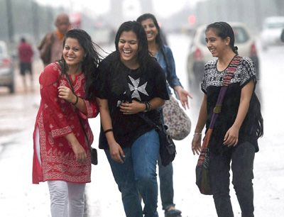 New Delhi: A group of girls revel in the rain at Rajpath in New Delhi on Sunday. PTI Photo by Atul Yadav(PTI7_13_2014_000088B)