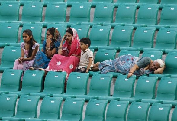 Spectators watch the men's hockey group match between Canada and Trinidad and Tobago in New Delhi