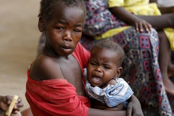 A child rescued from Boko Haram in Sambisa forest carries a baby in front of a clinic at the Malkohi camp for Internally Displaced People in Yola, Adamawa State, Nigeria May 3, 2015. Hundreds of traumatised Nigerian women and children rescued from Boko Haram Islamists have been released into the care of authorities at a refugee camp in the eastern town of Yola, an army spokesman said. REUTERS/Afolabi Sotunde