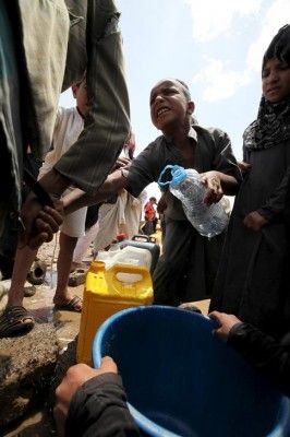 A boy fights for his turn to fill a jerrycan with water from a public tap, amidst water shortages in Sanaa May 13, 2015. A five-day humanitarian truce in Yemen appeared to be broadly holding on Wednesday, despite reports of some air strikes overnight by Saudi-led forces and continued actions by the country's dominant Houthi group in the east. REUTERS/Mohamed al-Sayaghi