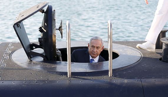 Israeli Prime Minister Benjamin Netanyahu climbs out after a visit inside the Rahav, the fifth submarine in the fleet, after it arrived in Haifa port January 12, 2016. The Dolphin-class submarines, widely believed to be capable of firing nuclear missiles, were manufactured in Germany and sold to Israel at deep discounts as part of Berlin's commitment to shoring up the security of the country set in part as a haven for Jews who survived the Holocaust.REUTERS/Baz Ratner - RTX221FU