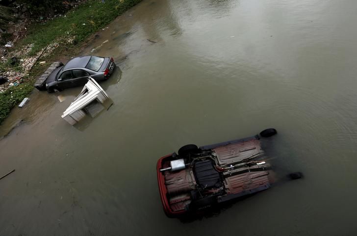 Vehicles are seen broken down and bring blown into sea by Typhoon Hato as Tropical storm Pakhar hits Macau, China August 27, 2017. REUTERS/Tyrone Siu