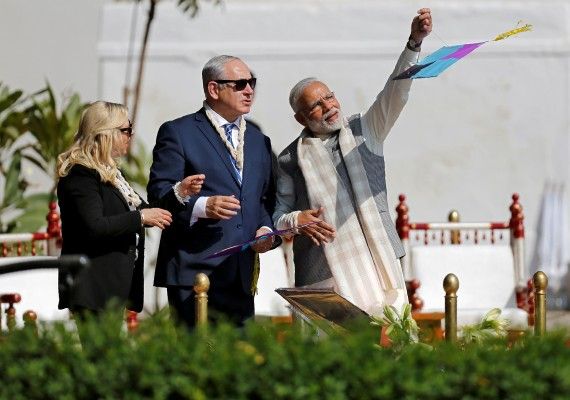 India's Prime Minister Narendra Modi flies a kite watched by his Israeli counterpart Benjamin Netanyahu and Netanyahu's wife Sara during their visit to Gandhi Ashram in Ahmedabad, India, January 17, 2018. REUTERS/Amit Dave - RC1B6A253320