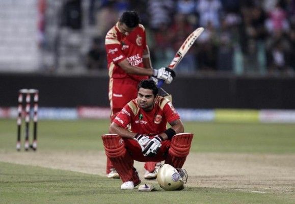 Royal Challengers Bangalore's Virat Kohli (front) reacts with Rahul Dravid looking on after losing their Twenty20 cricket match against the Mumbai Indians at Kingsmead Stadium in Durban, September 19, 2010. REUTERS/Rogan Ward (SOUTH AFRICA - Tags: SPORT CRICKET)