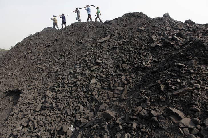 Workers walk on a heap of coal at a stockyard of an underground coal mine in the Mahanadi coal fields at Dera, near Talcher town in the eastern Indian state of Orissa March 28, 2012. India sits on the world's fifth-largest coal reserves, and produces the most after China and the United States. Picture taken March 28, 2012. To match INDIA-COAL/ REUTERS/Rupak De Chowdhuri (INDIA - Tags: BUSINESS ENERGY EMPLOYMENT)