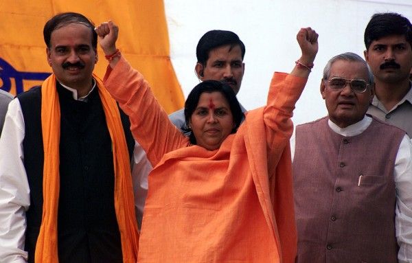 Bharatiya Janata Party leader and former Madhya Pradesh Chief Minister, Uma Bharti, attend a public rally in Amritsar. Bharatiya Janata Party (BJP) leader and former Madhya Pradesh Chief Minister, Uma Bharti (C), along with former Indian Prime Minister Atal Bihari Vajpayee (R), attend a public rally near Jalianwala Bagh in Amritsar September 25, 2004. REUTERS/Munish Sharma - RP5DRIAGBAAA