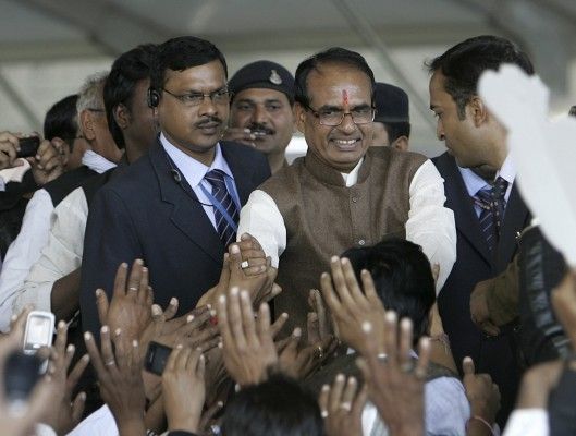 Shivraj Singh Chouhan (2nd R), chief minister of Madhya Pradesh, greets his Bharatiya Janata Party (BJP) supporters during Chouhan's swearing-in ceremony in the central Indian city of Bhopal December14, 2013. Five months before India's next elections are due, there is already an air of victory around Narendra Modi as he strides from one jam-packed rally to the next. And yet, a regional leader from his Hindu nationalist fold is quietly emerging as an alternative to lead the country. This month, Chouhan notched up a thumping election victory in Madhya Pradesh, a sprawling central state with a population larger than that of France, becoming its chief minister for a third time. Picture taken December 14, 2013. REUTERS/Raj Patidar (INDIA - Tags: POLITICS ELECTIONS PROFILE) - GM1E9CJ18QT01