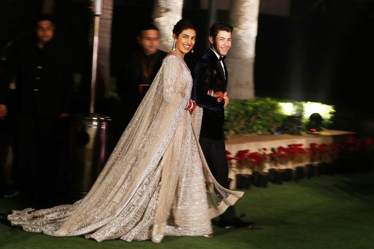 Mandatory Credit: Photo by Altaf Qadri/AP/REX/Shutterstock (10013599c) Priyanka Chopra, Nick Jonas. Bollywood actress Priyanka Chopra and musician Nick Jonas arrive for their wedding reception in New Delhi, India Chopra Jonas Wedding, New Delhi, India - 04 Dec 2018