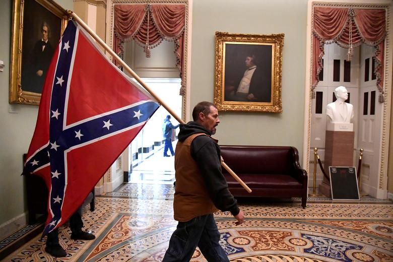 A Supporter Of President Trump Carries A Confederate Battle Flag On The Second Floor Of The Capitol Building, January 6. Reuters:mike Theiler