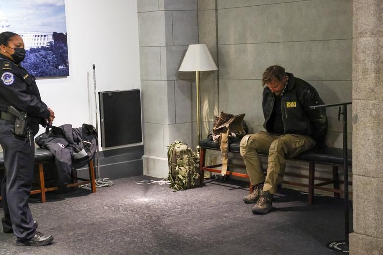 A U.s. Capitol Police Member Stands Guard In Front Of A Detained Protester Inside The U.s. Capitol, January 6. Reuters:jonathan Ernst