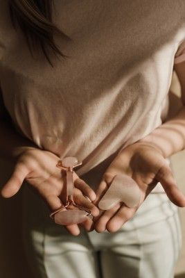 Gua Sha And Face Roller In Hand