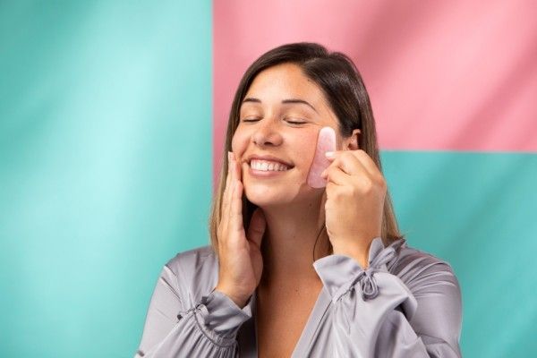 Portrait Gorgeous Woman Massaging Her Face Using Gua Sha