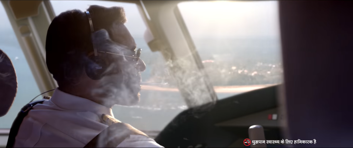 फिल्म 'रनवे 34' के एक सीन में कॉकपिट में सिगरेट पीता अजय देवनग का किरदार.